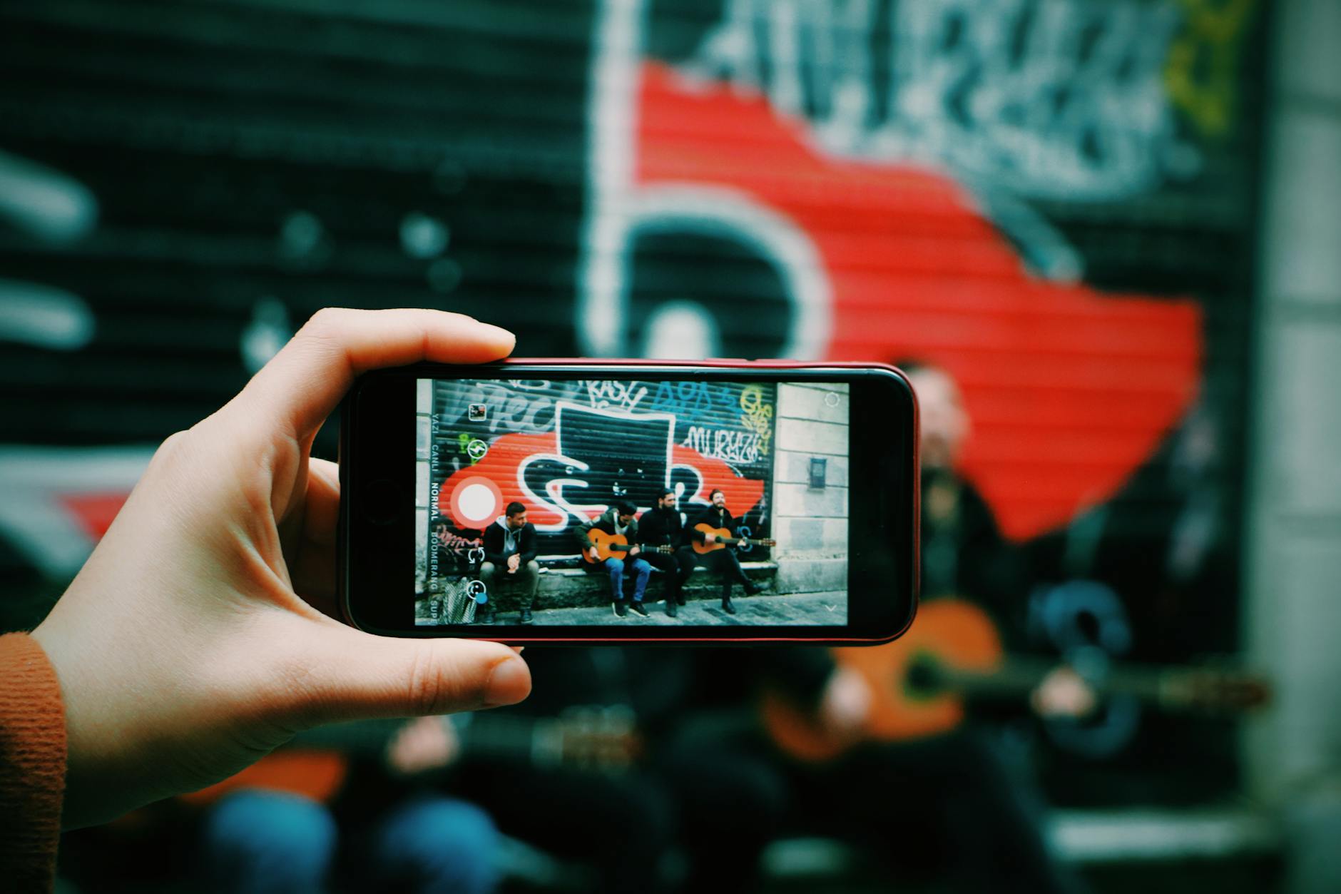 musician filming smartphone city street (Photo: aforizmart / Pexels)