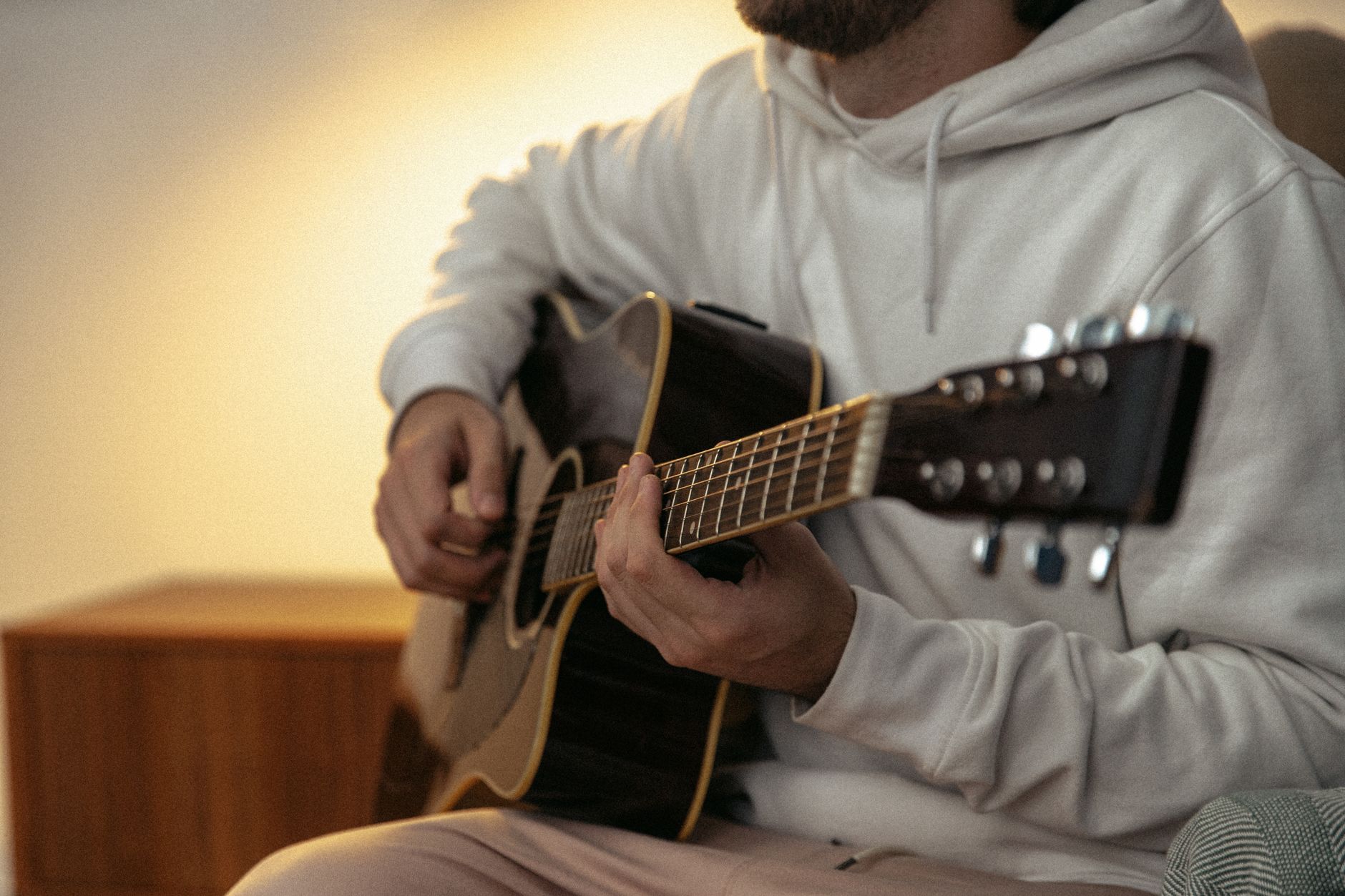 musician acoustic guitar warm light (Photo: SHVETS production / Pexels)