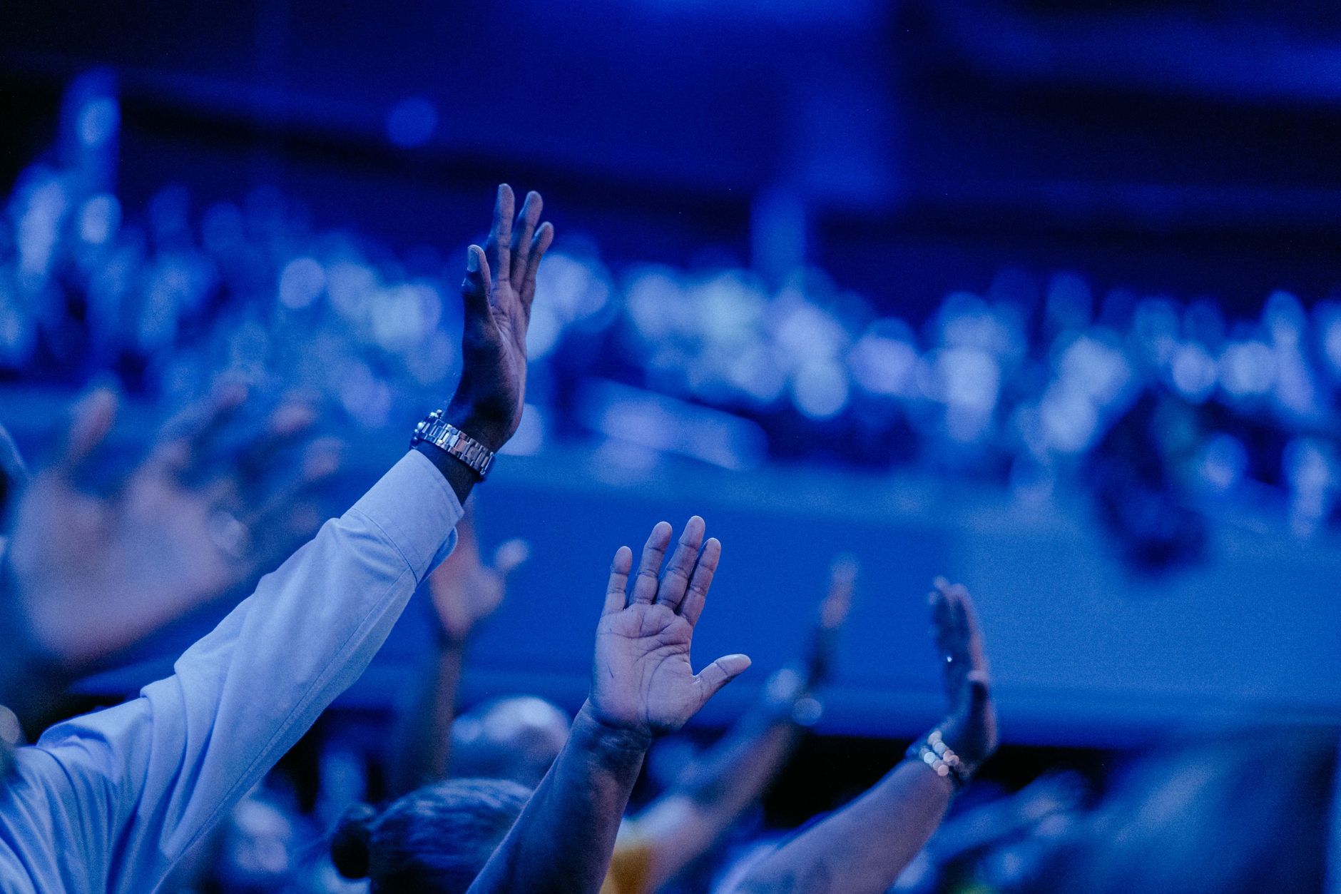 audience hands raised (Photo: Luis Quintero / Pexels)
