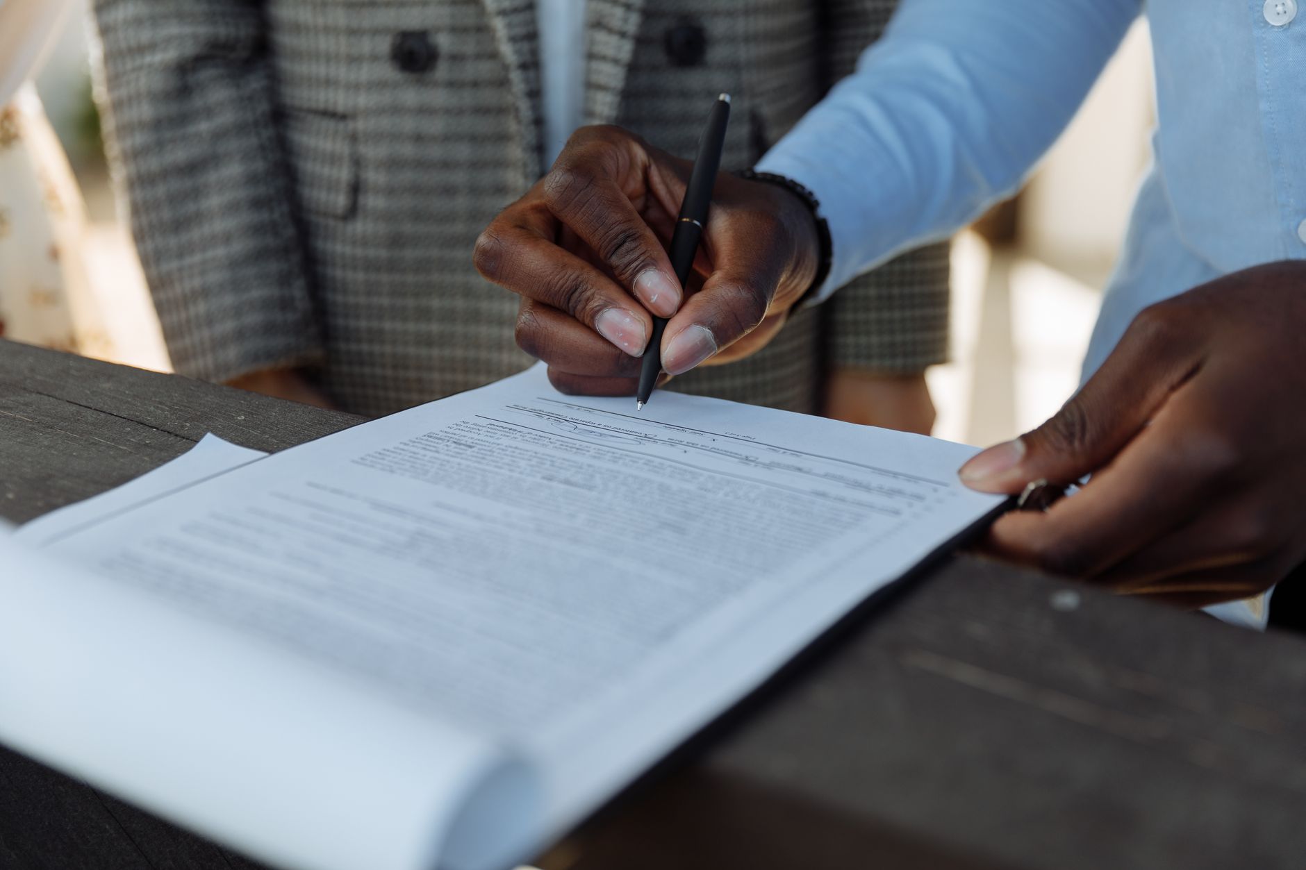 contract signing document (Photo: Thirdman / Pexels)