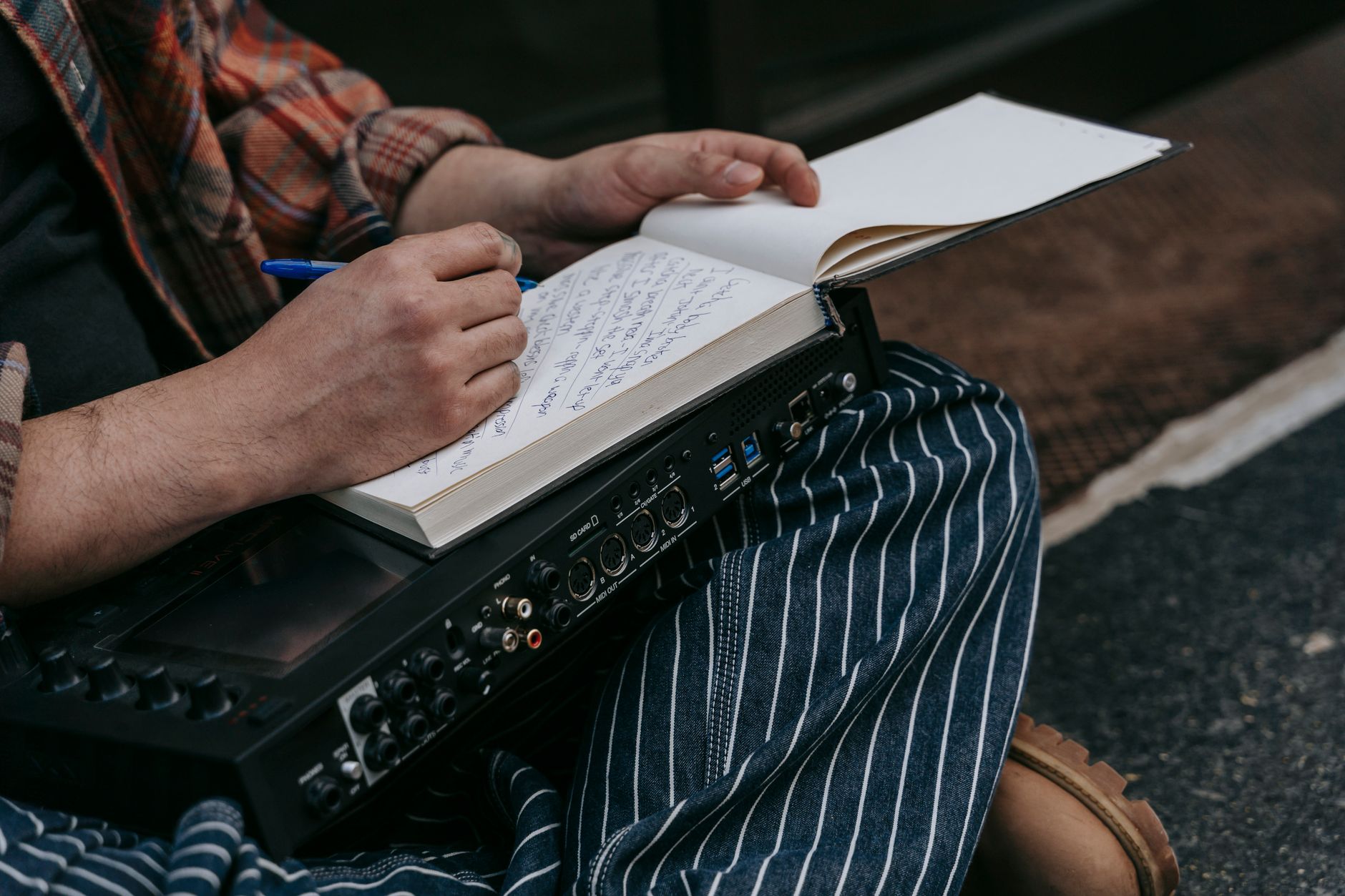 musician analyzing notebook (Photo: Anna Pou / Pexels)