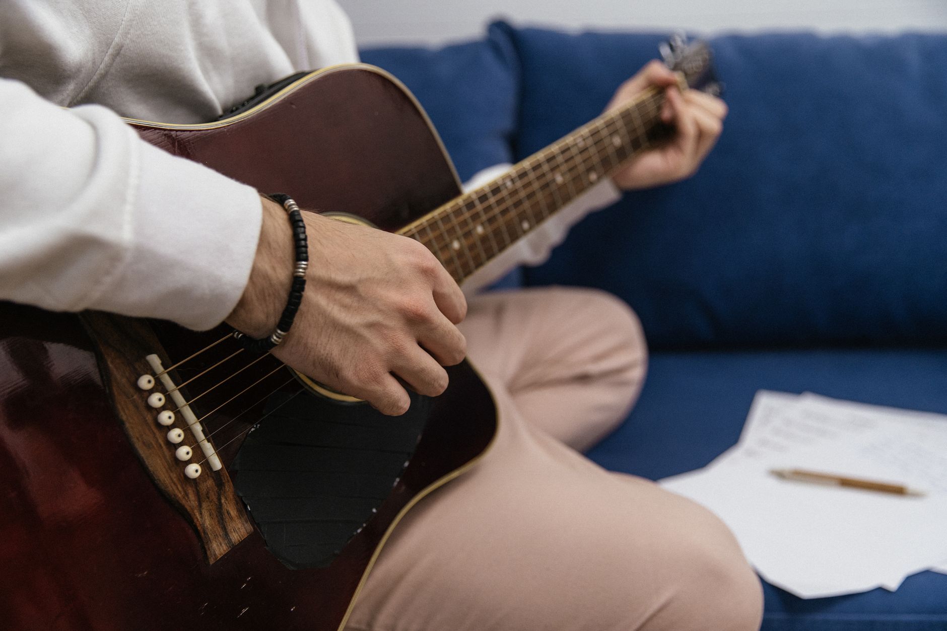 guitarist writing notes home (Photo: SHVETS production / Pexels)