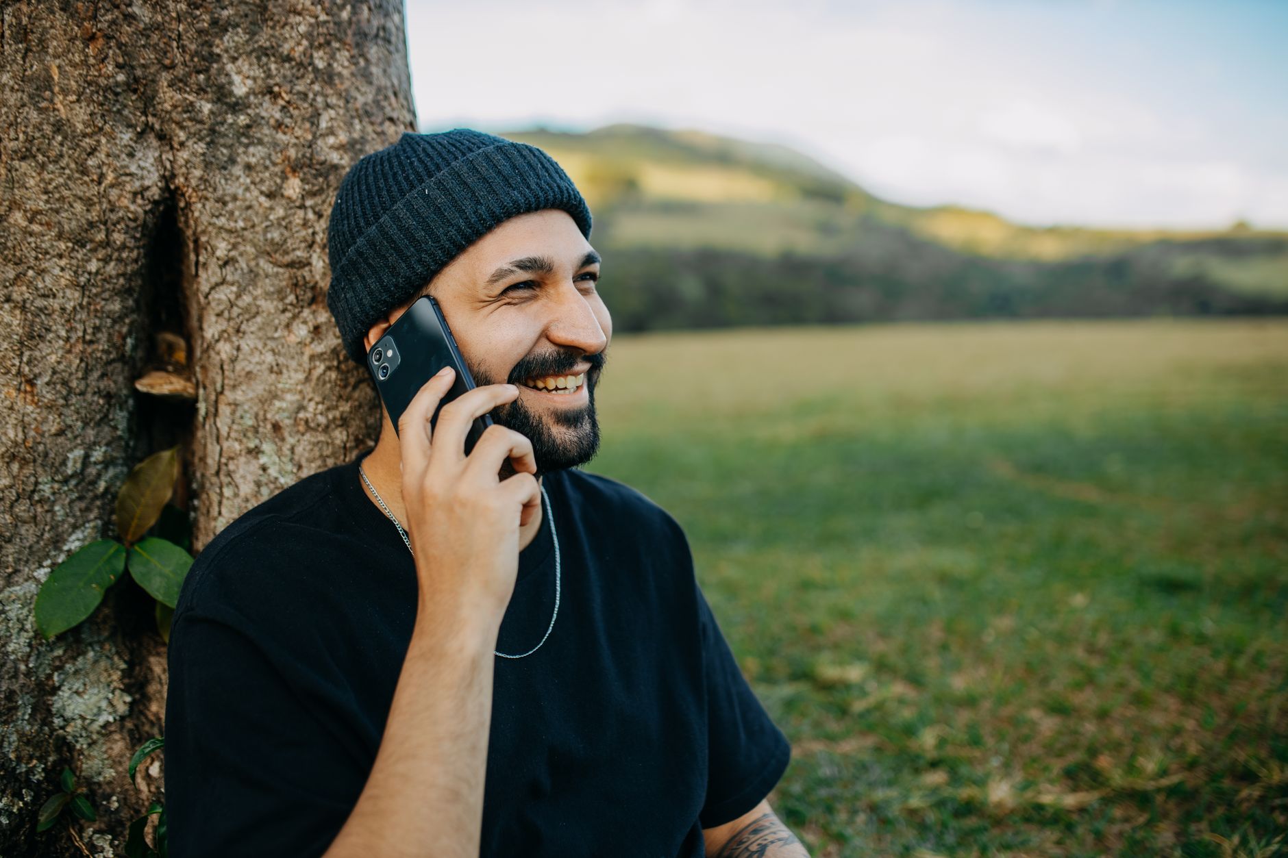 musician smiling with phone (Photo: Matheus Bertelli / Pexels)