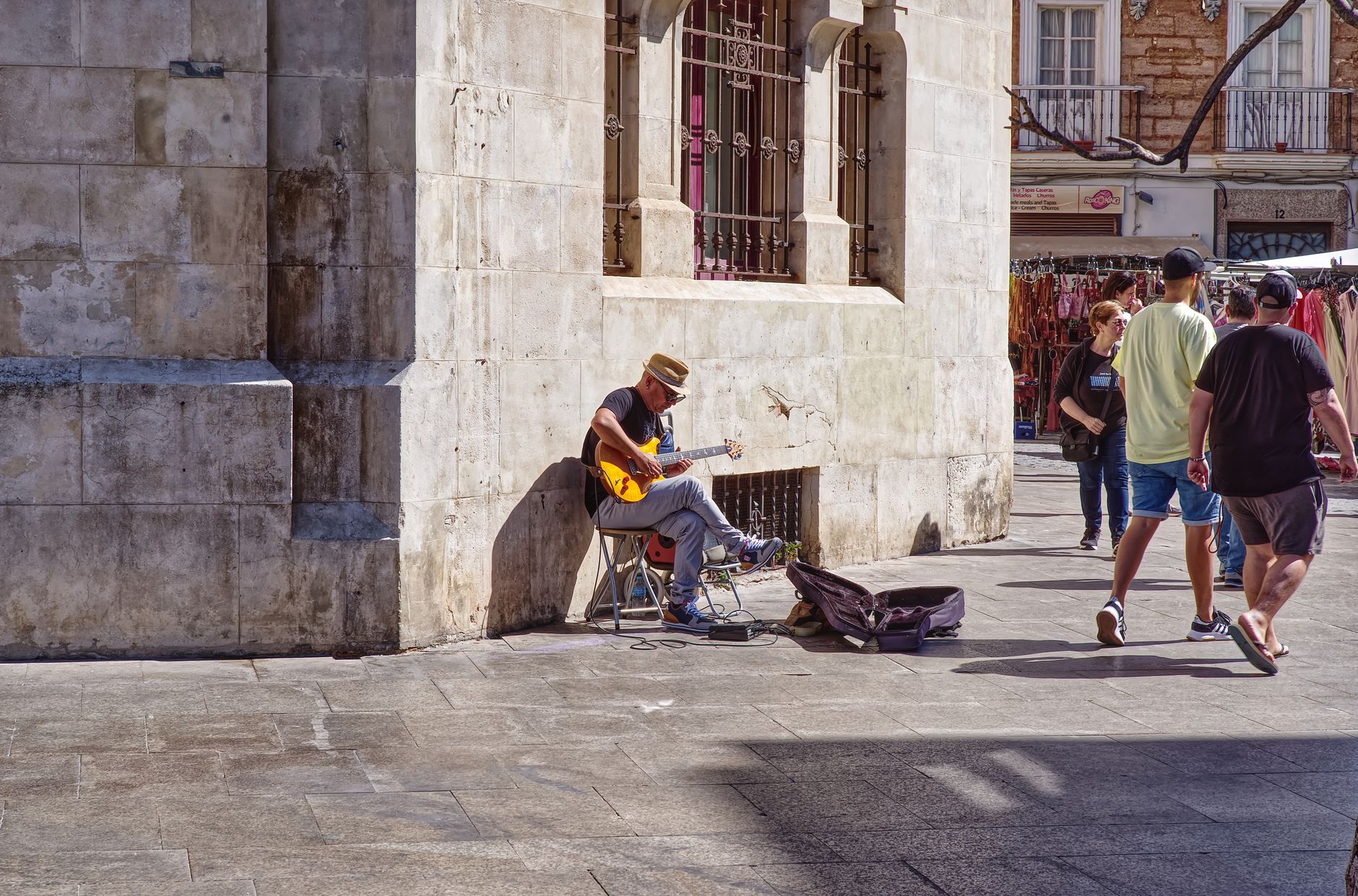musician sitting guitar case (Photo: Mark Thomas / Pexels)