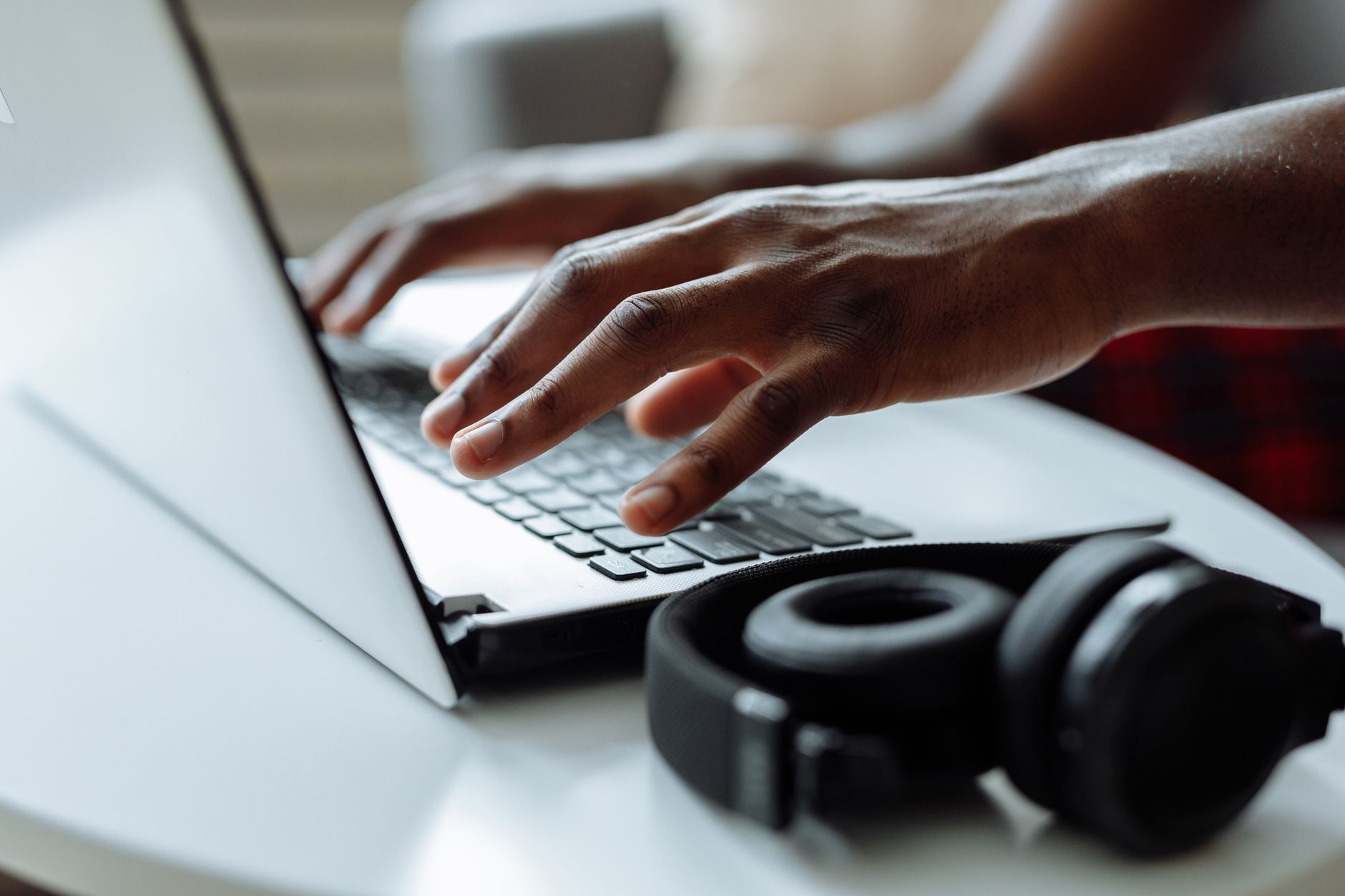 person typing laptop headphones (Photo: Thirdman / Pexels)
