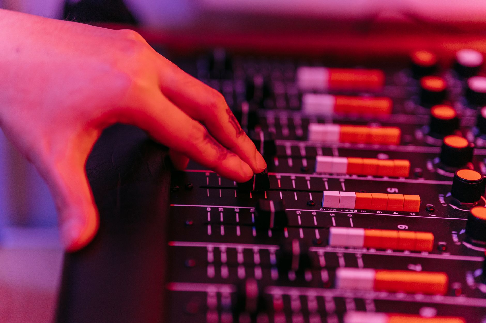 hands adjusting studio equipment (Photo: Anna Pou / Pexels)