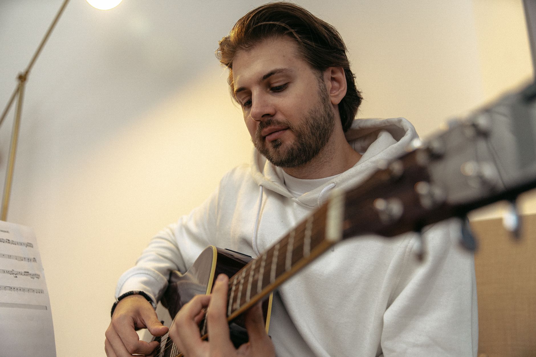 guitarist practicing sheet music (Photo: SHVETS production / Pexels)