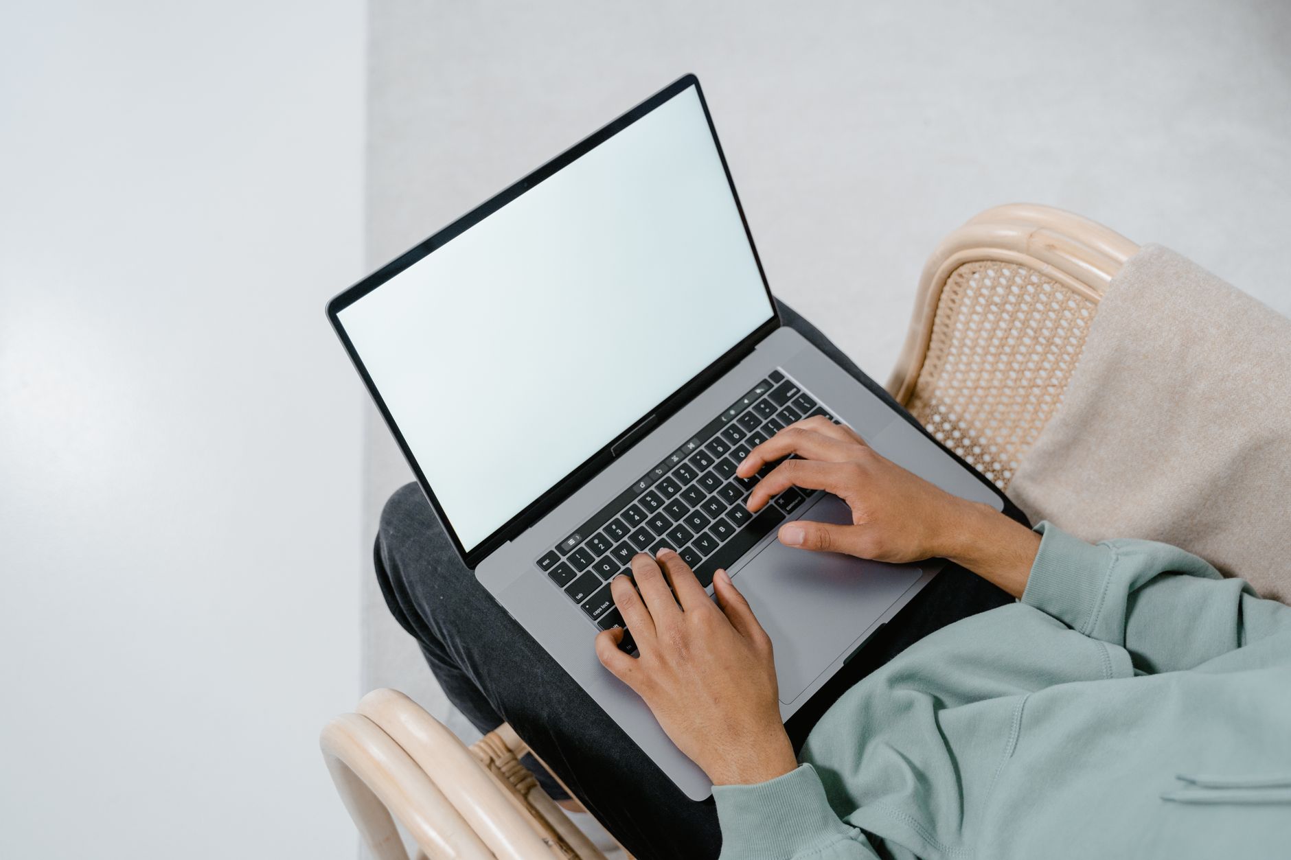 person setting up laptop (Photo: MART  PRODUCTION / Pexels)