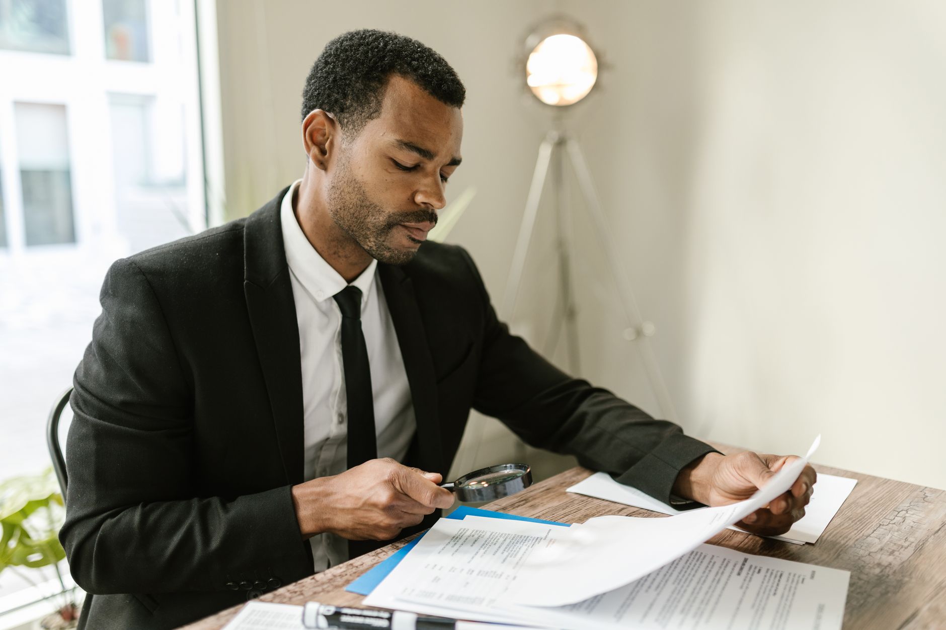reading documents magnifying glass (Photo: RDNE Stock project / Pexels)